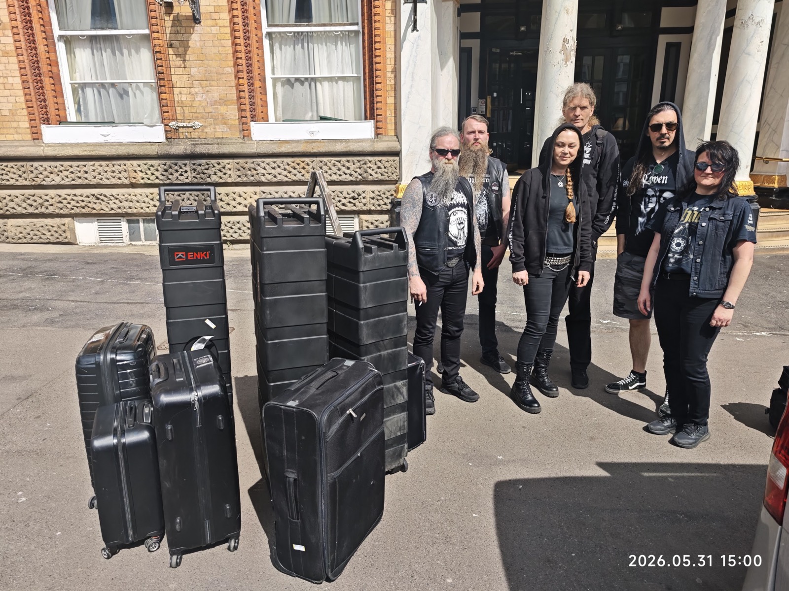 Group of passengers with their travel cases, ready for pickup