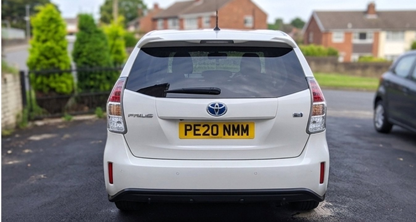White Toyota Prius+ hybrid taxi, rear view