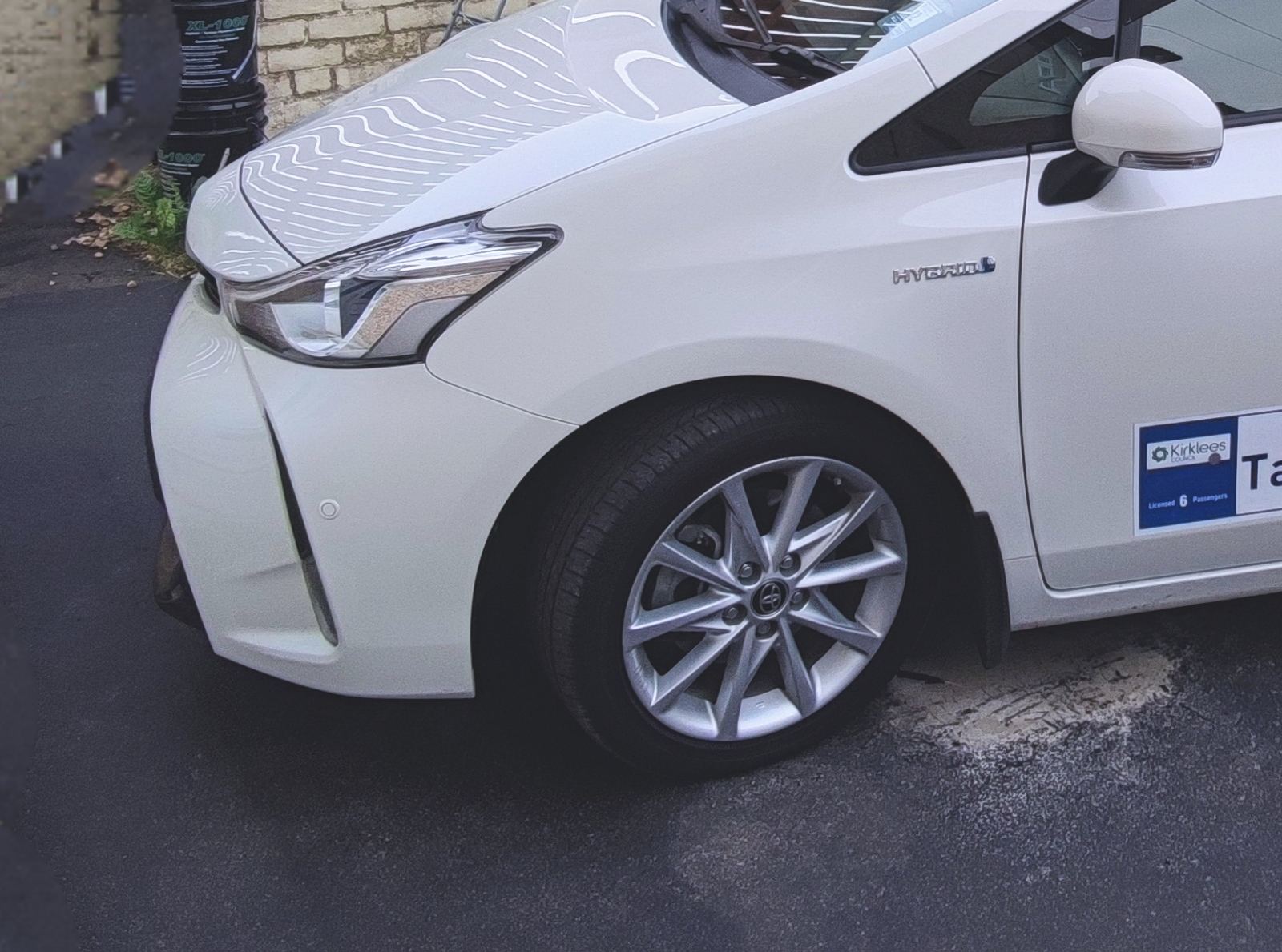 White Toyota Prius+ hybrid taxi, licensed taxi plate